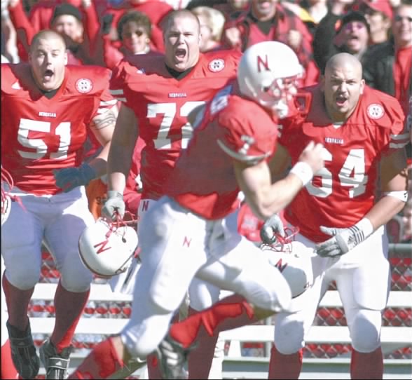 Eric Crouch sprints down the sideline for his fourth-quarter touchdown as teammates cheer him on.