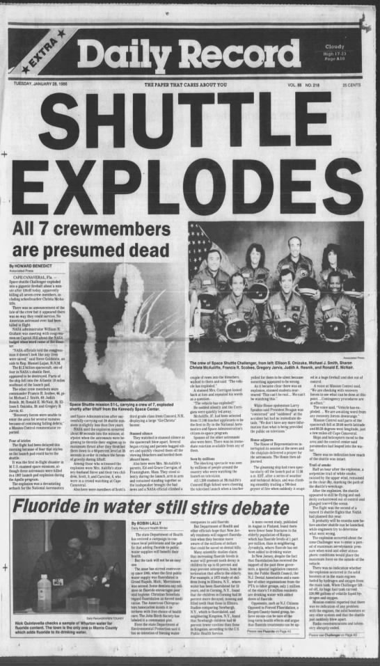 Space Shuttle Challenger explodes; newspaper front page includes photo of crew members - 