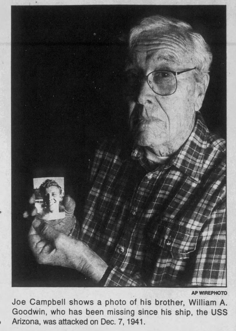 Joe Campbell (formerly Finley Goodwin) holds a photo of Bill Goodwin who died aboard the USS Arizona