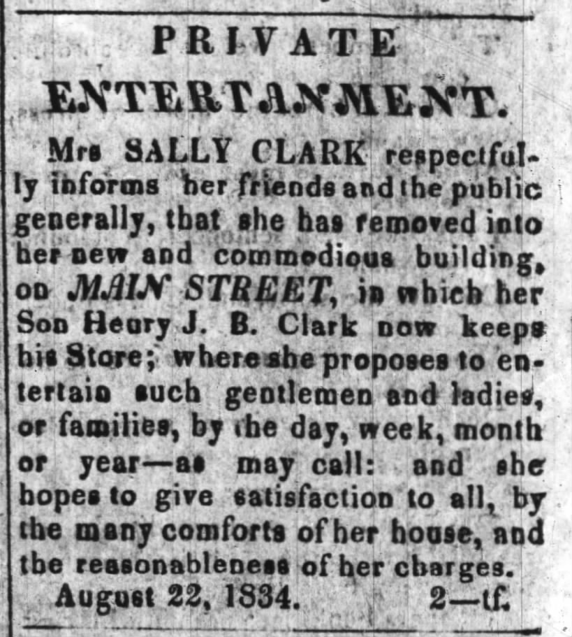 Mrs. Sally Clark is in new building on Main Street in which her son, Henry, keeps his store.