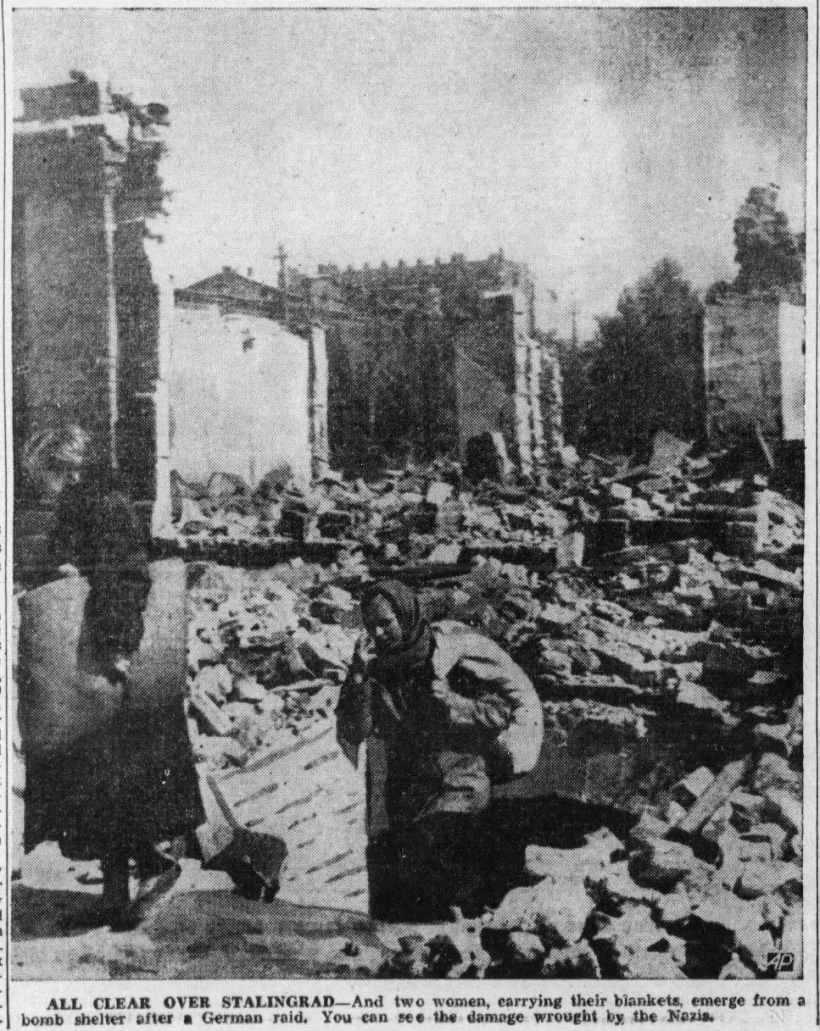 Picture of the damage in Stalingrad while two women emerge from a bomb shelter after a German raid