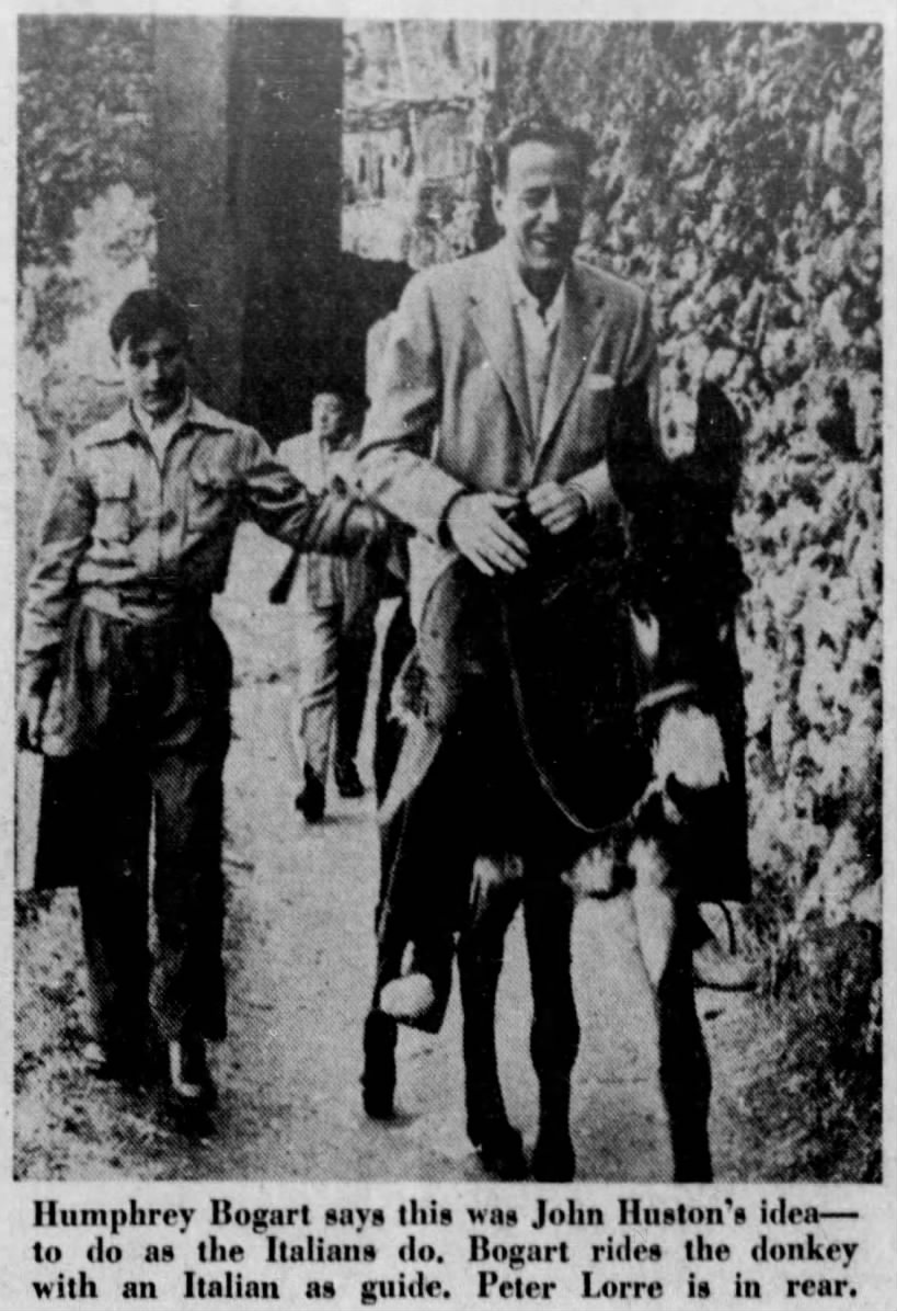 Photo of Humphrey Bogart riding a donkey in Italy; Says it was John Huston's idea