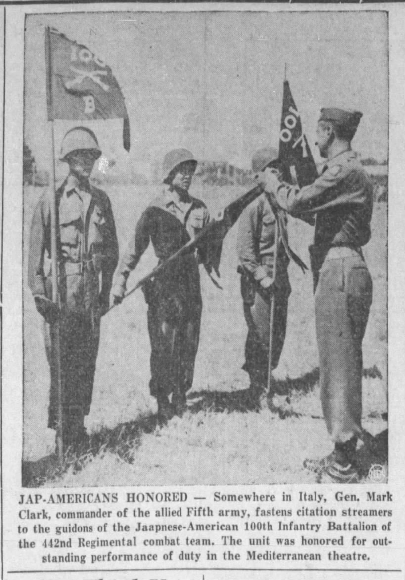 Photo of General Mark Clark pinning citation streamers on soldiers of the 100th Infantry Battalion