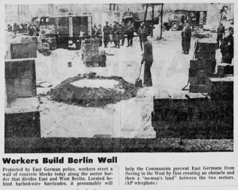 Photo of workers building the Berlin Wall in August 1961
